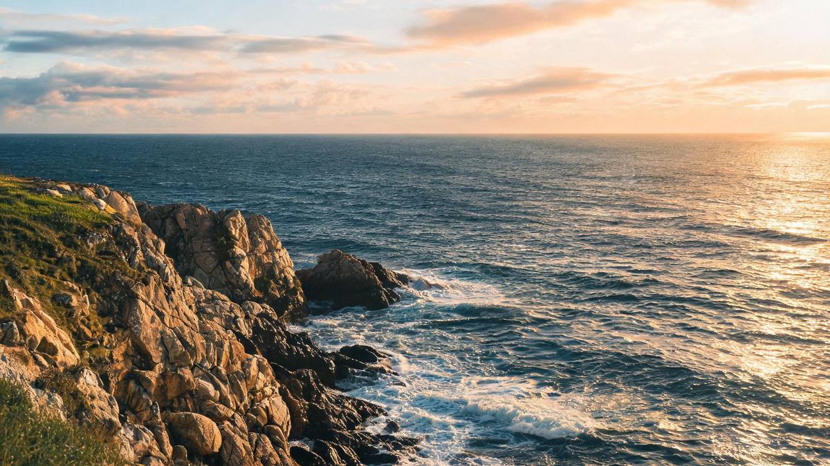 A coastal cliff landscape at golden hour with sea and sky, no person