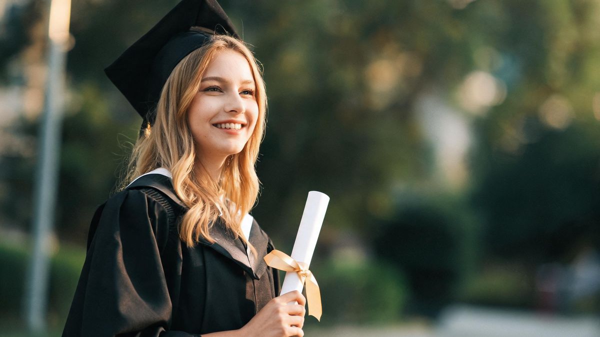 A graduate holding a diploma, soft light, happy expression.