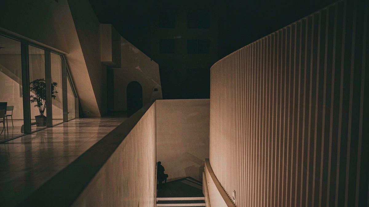 An abstract architectural interior with strong geometry and deep shadow