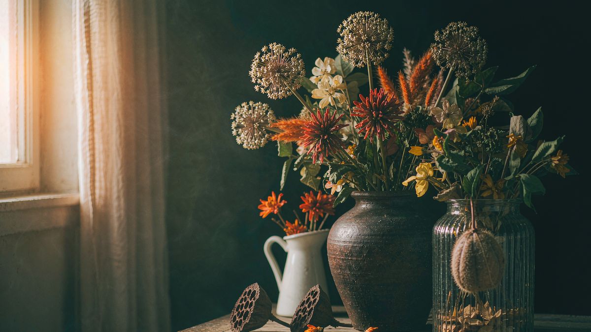 A seasonally styled still life on a wooden table in warm window light
