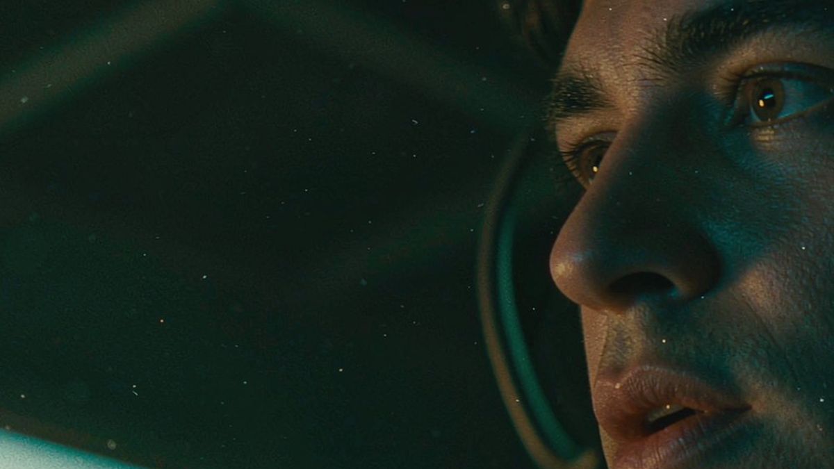 Close-up of a man’s face in profile under low blue light
