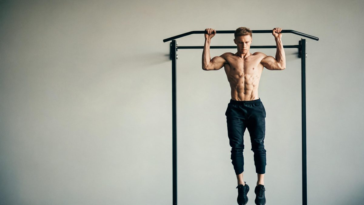 A man with European features in a plain gym, his arms and torso gaining definition mid-motion, neutral background, soft side light