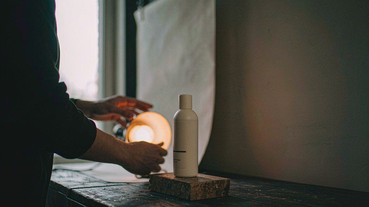 A skincare bottle on a stone slab during a tabletop product shoot