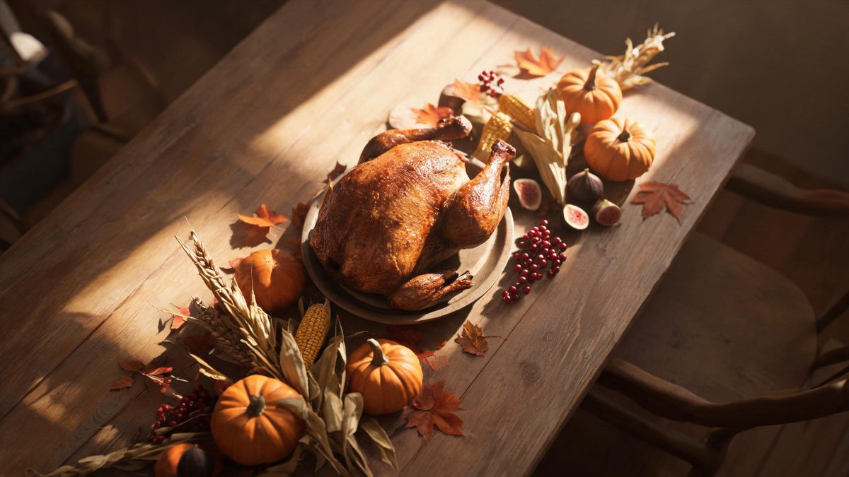 Overhead view of a harvest table set for a small gathering in late afternoon window light