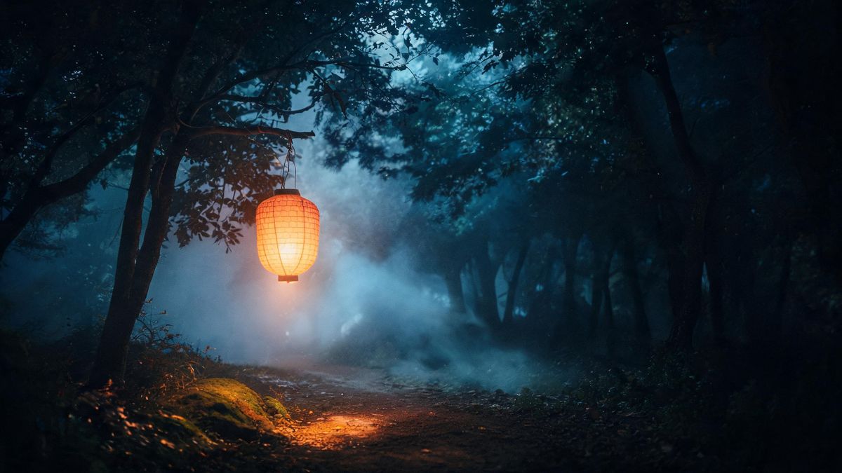 A lantern hanging from a branch on a foggy forest path at night, blue darkness through the trees