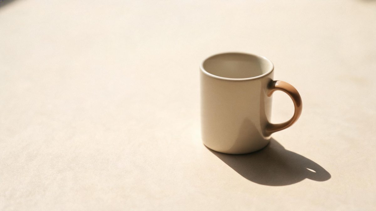 A a professional head-and-shoulders shot on a plain surface, lit from one side with soft shadow, broken apart at the moment of the cut