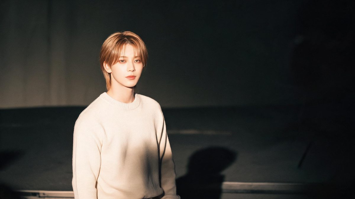 A a pop idol on stage on a plain surface, lit from one side with soft shadow, broken apart at the moment of the cut