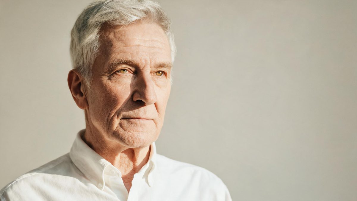 A an older version of the subject on a plain surface, lit from one side with soft shadow, broken apart at the moment of the cut