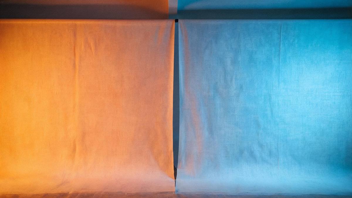 A soft gradient blending a warm studio backdrop into a cool one, no figures