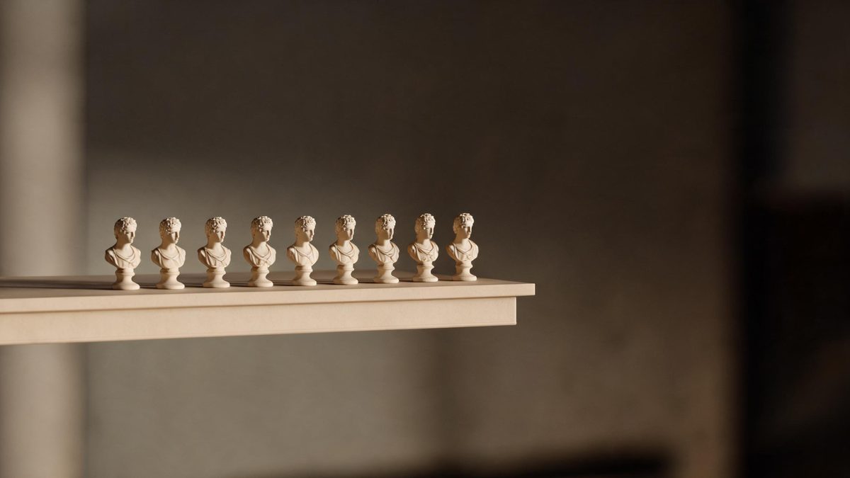 A row of nine small identical ceramic busts on a pale shelf under soft even studio light