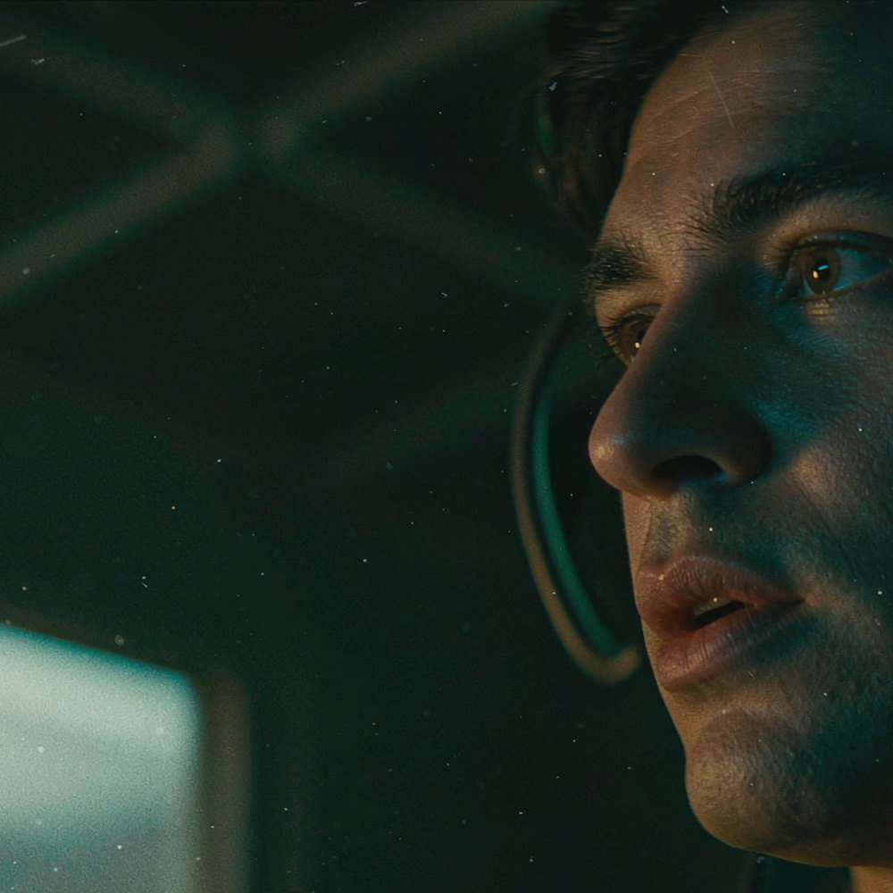 A close-up of an actor in a dubbing booth with light tracing his lips, representing AI lip sync and dialogue by OpenFilmo
